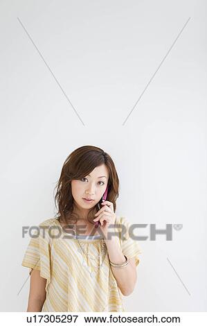 Young woman on cell phone View Large Photo Image Stock Photo - Young woman on cell phone. Fotosearch