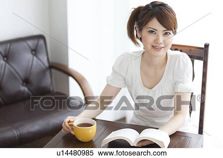 Stock Photography - Young woman reading a book. Fotosearch