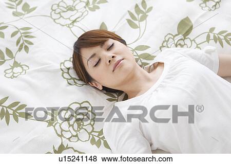 Stock Photo - Young woman sleeping. Fotosearch