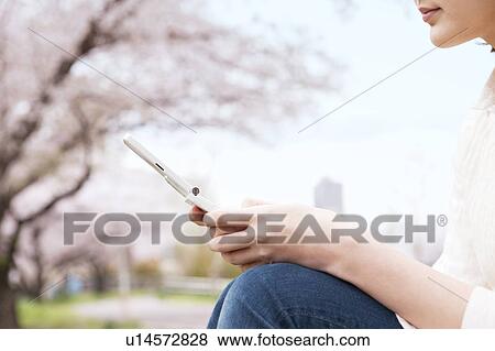 Young woman text messaging View Large Photo Image Stock Photo - Young woman text messaging. Fotosearch