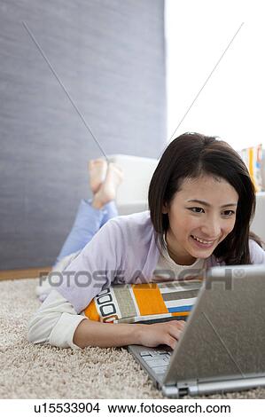 Young woman using laptop View Large Photo Image Picture - Young woman using laptop. Fotosearch