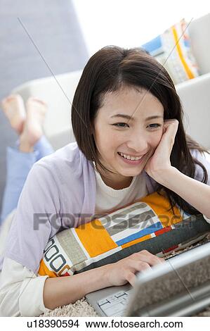 Young woman using laptop View Large Photo Image Picture - Young woman using laptop. Fotosearch
