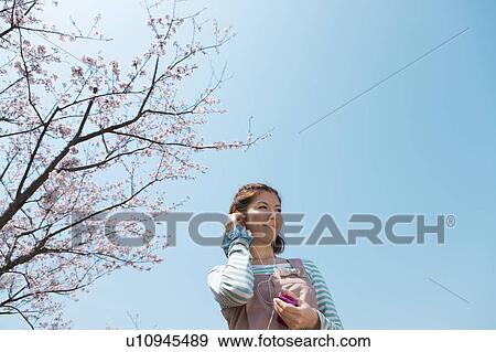 Young woman with headphones on View Large Photo Image Stock Photo - Young woman with headphones on. Fotosearch