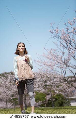 Young woman with headphones on View Large Photo Image Stock Photo - Young woman with headphones on. Fotosearch