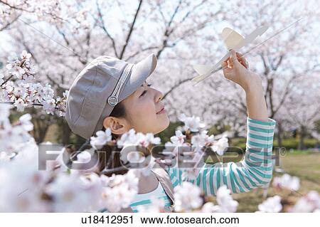Young woman with paper airplane View Large Photo Image Stock Image - Young woman with paper airplane. Fotosearch