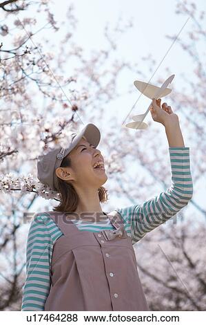 Stock Photo - Young woman with paper airplane. Fotosearch