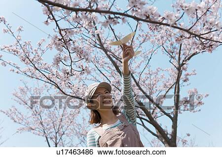 Young woman with paper airplane View Large Photo Image Stock Photograph - Young woman with paper airplane. Fotosearch