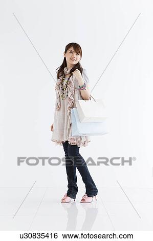 Young woman with shopping bags View Large Photo Image Stock Photograph - Young woman with shopping bags. Fotosearch