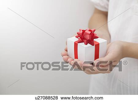 A girl holding a present View Large Photo Image Stock Photo - A girl holding a present. Fotosearch