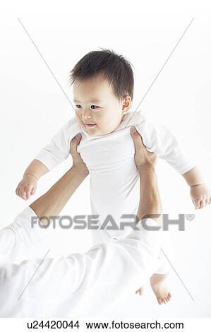 Picture - Baby Being Lifted Up. Fotosearch