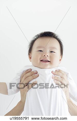 Stock Image - Baby Being Lifted Up. Fotosearch