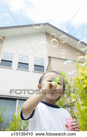 Baby Boy Blowing Bubbles, Low Angle View View Large Photo Image Stock Image - Baby Boy Blowing Bubbles, Low Angle View. Fotosearch