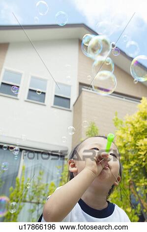 Baby Boy Blowing Bubbles, Low Angle View View Large Photo Image Stock Photograph - Baby Boy Blowing Bubbles, Low Angle View. Fotosearch