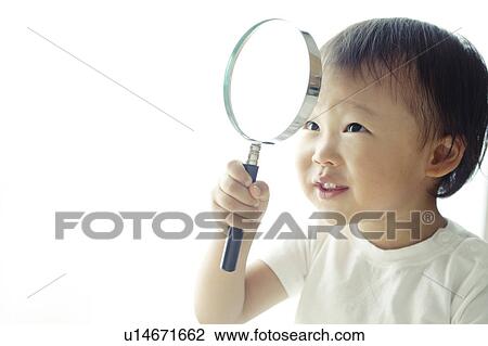 Stock Image - Baby Boy Looking Through Magnifying Glass. Fotosearch