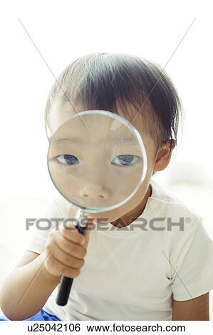 Stock Photograph - Baby Boy Looking Through Magnifying Glass. Fotosearch