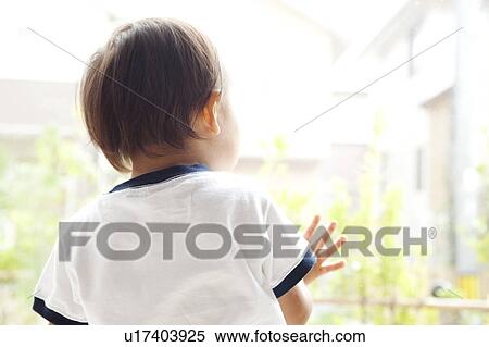 Stock Photography - Baby Boy Looking Through Window. Fotosearch