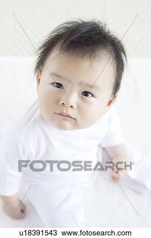 Stock Image - Baby Boy Looking Up, High Angle View. Fotosearch