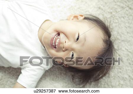 Baby Boy Lying on Floor and Laughing View Large Photo Image Stock Photo - Baby Boy Lying on Floor and Laughing. Fotosearch