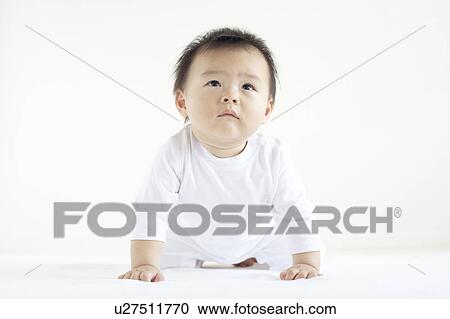 Stock Image - Baby Boy On Hands And Knees Looking Up. Fotosearch