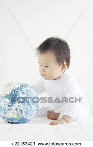 Stock Image - Baby Boy Playing with Globe. Fotosearch