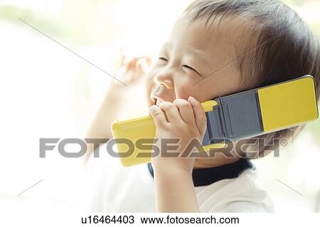 Stock Image - Baby Boy Talking On Phone. Fotosearch
