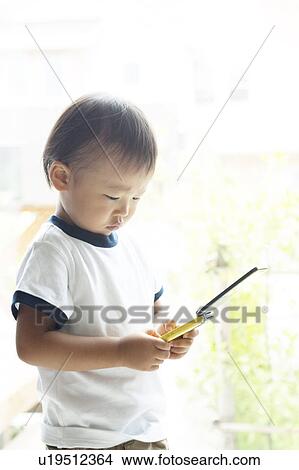 Picture - Baby Boy Using Mobile Phone. Fotosearch
