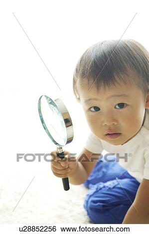 Stock Photograph - Baby Boy with Magnifying Glass. Fotosearch