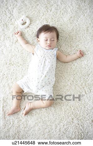 Baby lying down on carpet sleeping View Large Photo Image Stock Photo - Baby lying down on carpet sleeping. Fotosearch