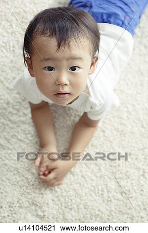 Stock Image - Boy Lying on Floor. Fotosearch