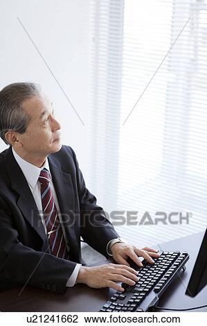 Stock Image - Businessman Typing. Fotosearch
