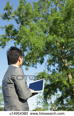 Stock Image - Businessman Using Laptop. Fotosearch