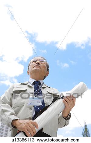 Stock Image - Businessman with ID Card and Blueprint. Fotosearch