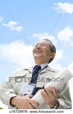 Stock Photograph - Businessman with ID Card and Blueprint. Fotosearch