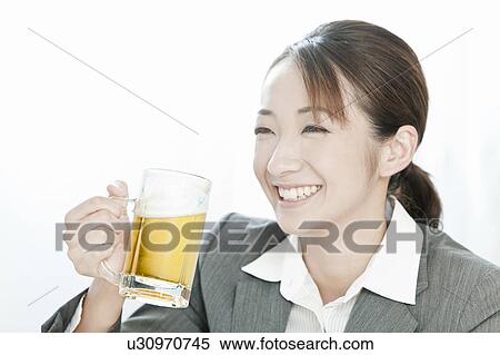 Businesswoman drinking a glass of beer, Tokyo Prefecture, Japan View Large Photo Image Stock Photography - Businesswoman drinking a glass of beer, Tokyo Prefecture, Japan. Fotosearch