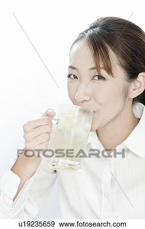 Businesswoman drinking a glass of highball, Tokyo Prefecture, Japan View Large Photo Image Stock Photo - Businesswoman drinking a glass of highball, Tokyo Prefecture, Japan. Fotosearch