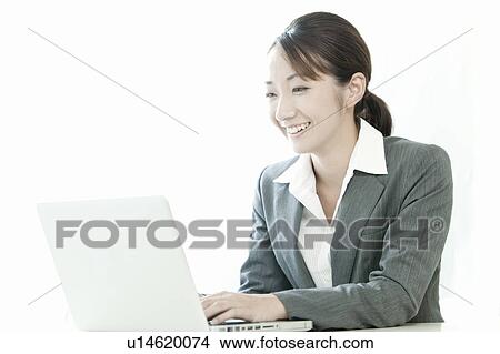 Businesswoman using a laptop, Tokyo Prefecture, Japan View Large Photo Image Picture - Businesswoman using a laptop, Tokyo Prefecture, Japan. Fotosearch