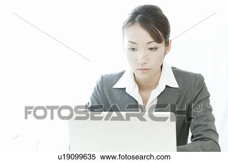 Stock Photography - Businesswoman using a laptop, Tokyo Prefecture, Japan. Fotosearch