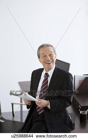 Cheerful Mature Businessman with Newspaper View Large Photo Image Picture - Cheerful Mature Businessman with Newspaper. Fotosearch