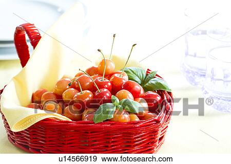Cherries in a basket and glasses of water View Large Photo Image Stock Photo - Cherries in a basket and glasses of water. Fotosearch