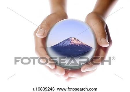 Stock Image - Child Holding Globe Showing Mount Fuji. Fotosearch
