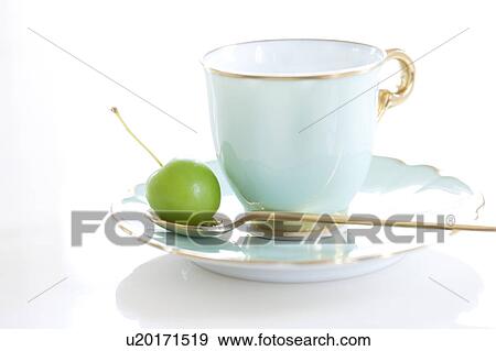 Stock Photo - Chinese Crabapple on Spoon Beside Porcelain Coffee Cup. Fotosearch
