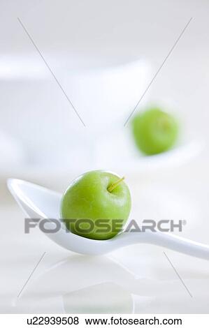 Stock Photo - Chinese Crabapple on Spoon Beside Porcelain Coffee Cup. Fotosearch