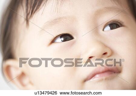 Close-up of baby's face View Large Photo Image Stock Photograph - Close-up of baby's face. Fotosearch