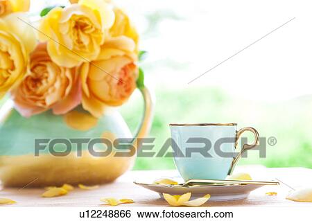 Stock Photograph - Coffee cup and rose petals. Fotosearch