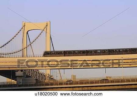 Stock Image - Commuter Train at Rainbow Bridge. Fotosearch