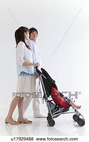 Couple Pushing Son in Buggy View Large Photo Image Stock Photo - Couple Pushing Son in Buggy. Fotosearch