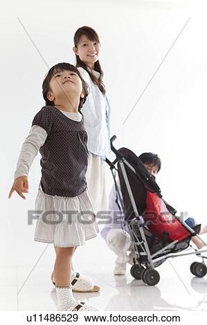 Daughter Looking Up, Parents in Background View Large Photo Image Stock Photo - Daughter Looking Up, Parents in Background. Fotosearch