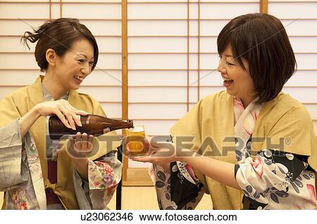 Daughter Pouring Beer For Her Mother View Large Photo Image Stock Photograph - Daughter Pouring Beer For Her Mother. Fotosearch