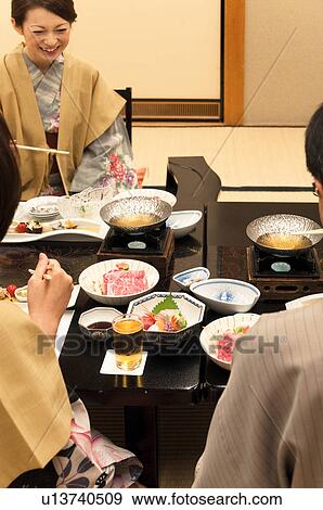 Stock Photo - Family of Three Having Dinner. Fotosearch