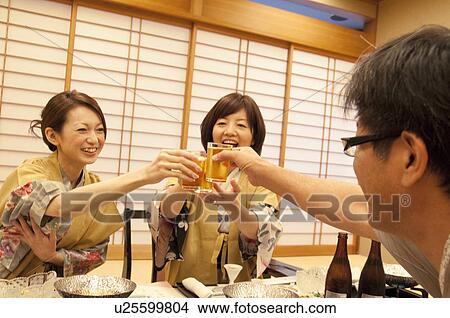 Picture - Family of Three Toasting at Dinner. Fotosearch
